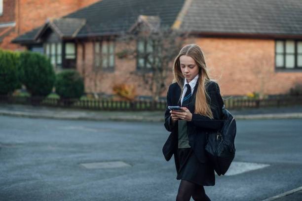 Girl Walking to School on Phone
